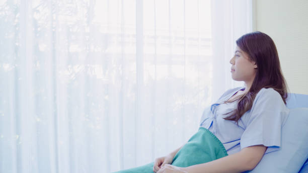 Beautiful Asian patient sick and sleeping while staying on Patient's bed at hospital. Medicine and health care concept. Beautiful Asian patient sick and sleeping while staying on Patient's bed at hospital. Medicine and health care concept. maternity ward stock pictures, royalty-free photos & images