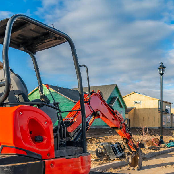 istock Clear Square Red excavator on a construction site for new homes against cloudy blue sky 1150349199