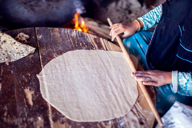 Arab woman makes bread in the beduin village in Egypt.