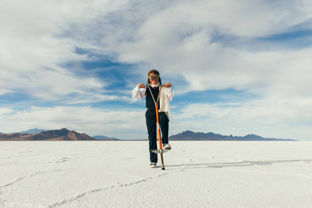 istock Young Boy Businessman On Pogo Stick 1150352577
