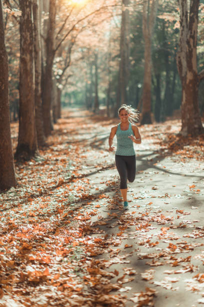 istock Woman Jogging Outdoors in The Fall 1150354018