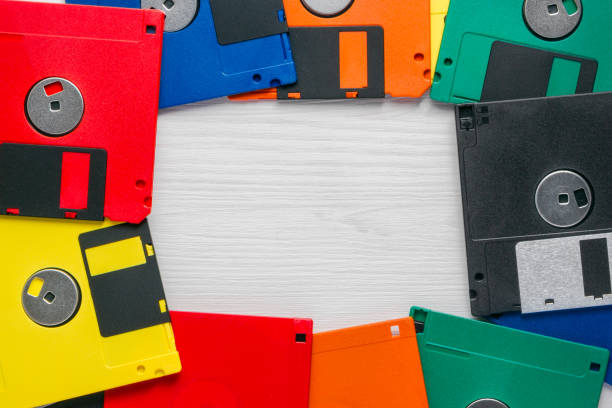 istock Vintage multi-colored floppy disk on white wooden background 1150354240