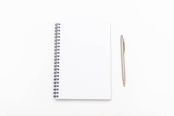 istock blank sheet of notebook with a spiral and pen on a white background. Copy space. 1150355353