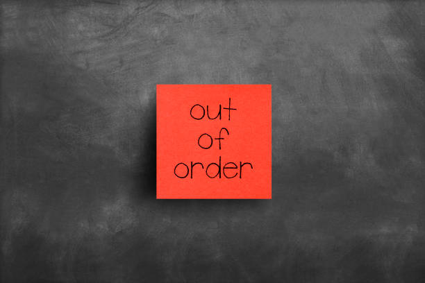 istock Sticky note on blackboard, Out of order 1150359353