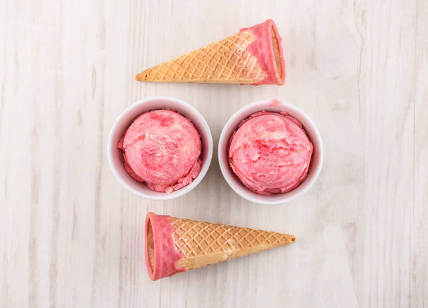 strawberry ice cream with bowl on wooden background stock photo