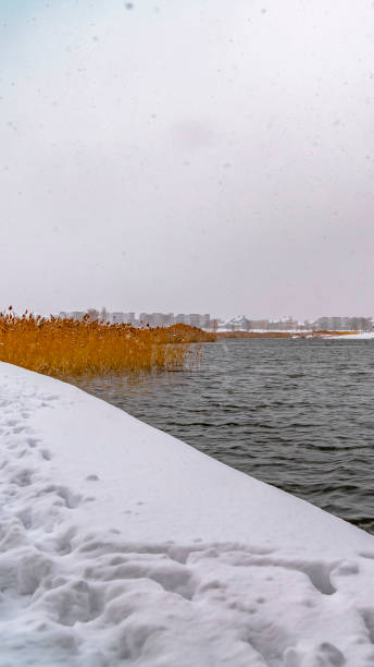 istock Vertical Snowy lake shore with homes in Daybreak Utah 1150361018