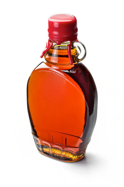 maple syrup maple syrup isolated on white maple syrup stock pictures, royalty-free photos & images