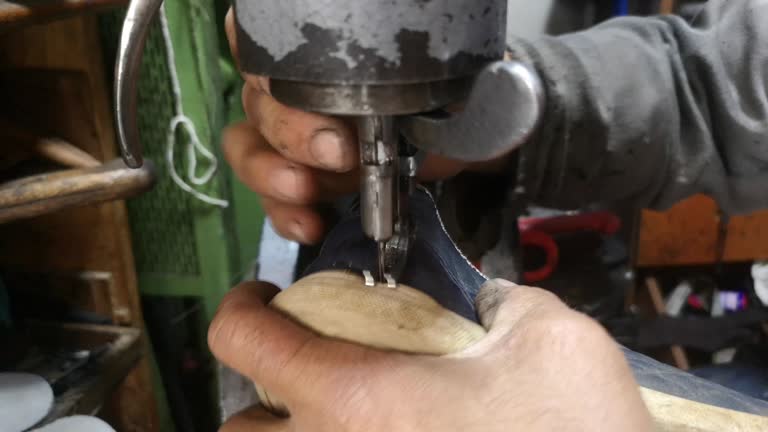 Shoe maker is repairing shoe