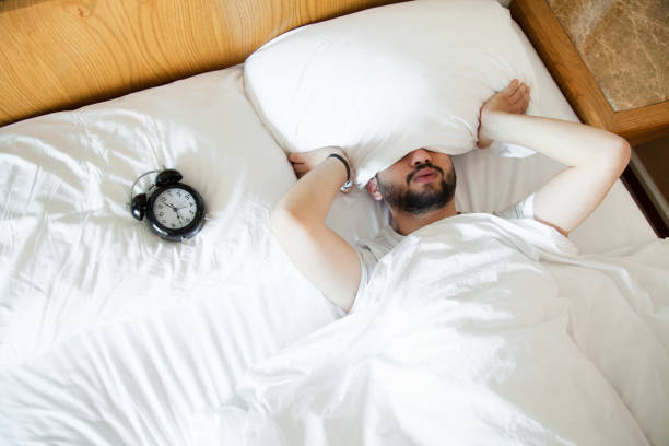 istock Young man finding it difficult to wake up in the morning 1150372389