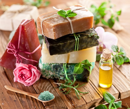 Piece of natural soap with herbs and flowers.