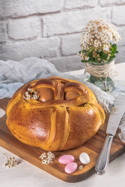 istock Portuguese traditional Easter cake. Folar with eggs on wooden table 1150374898