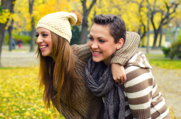 istock Beautiful happy girlfriends having fun in the park 1150377787