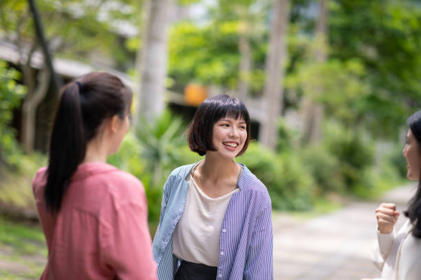 istock Young women talking in public park 1150379298