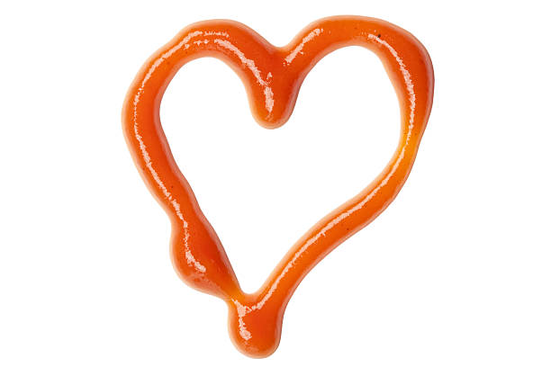 A heart made out of ketchup on a white background stock photo