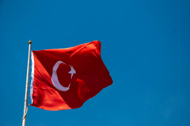 istock Turkish national flag with white star and moon in sky 1150383036