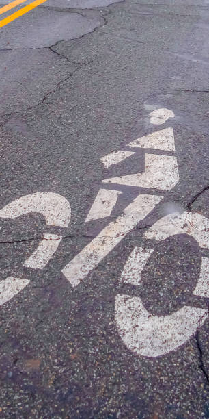istock Clear Vertical Bicycle lane sign painted on a road with cracks 1150383478