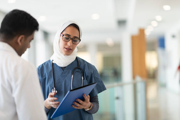 istock Two doctors discuss treatment plan in hospital corridor 1150384300