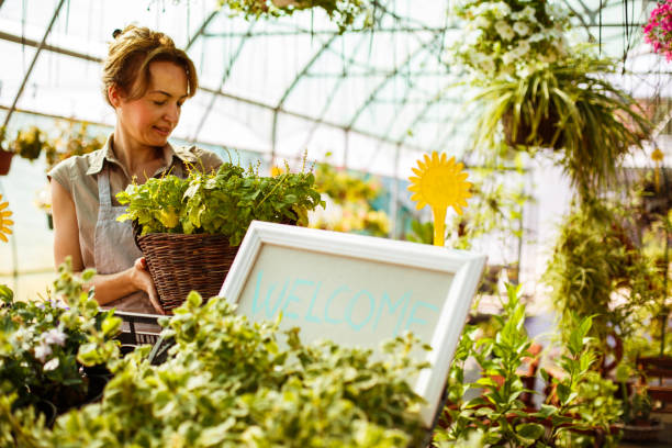 istock Florist caring for plants at garden center 1150384458