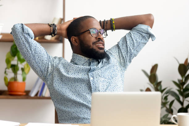 istock Calm african businessman take break at workplace relaxing finished work 1150384549