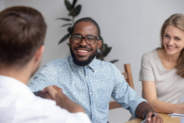 istock Happy african hr recruit handshake hire candidate at job interview 1150384603