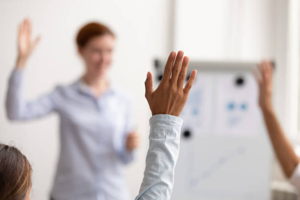 istock Business people raise hands up engaged in voting at conference 1150384620