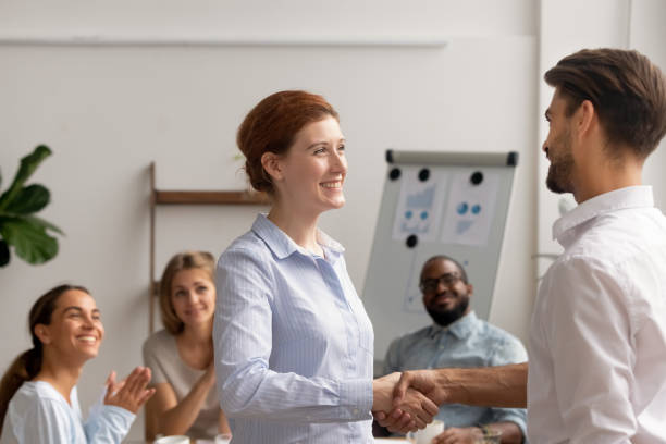 istock Happy female employee intern handshake helpful boss get rewarded promoted 1150384638