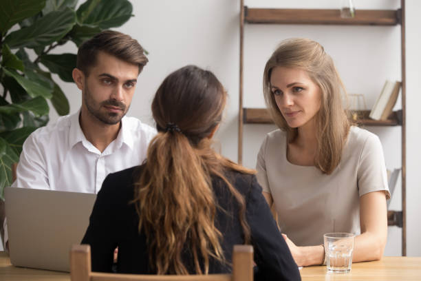 istock Serious doubtful hr managers listening to applicant at job interview 1150384643