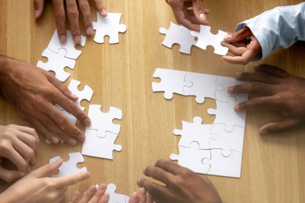 istock Teamwork concept, business team people hands assemble puzzle together 1150384650