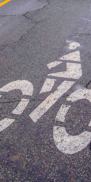 istock Clear Vertical Bicycle lane symbol painted on a damaged road 1150392313