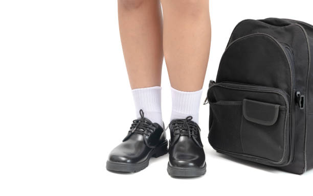 Student wear a black leather shoes and school bag. Asian Thai boy school student wear a black leather shoes stand with school bag isolated on white background, back to school concept dress shoe photos stock pictures, royalty-free photos & images
