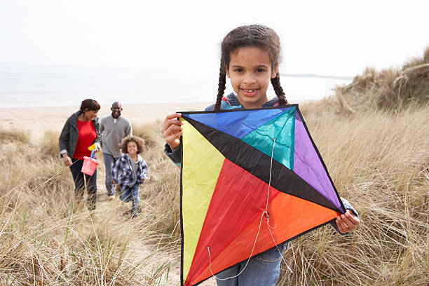 istock Family Having Fun With Kite In Sand Dunes 115039600