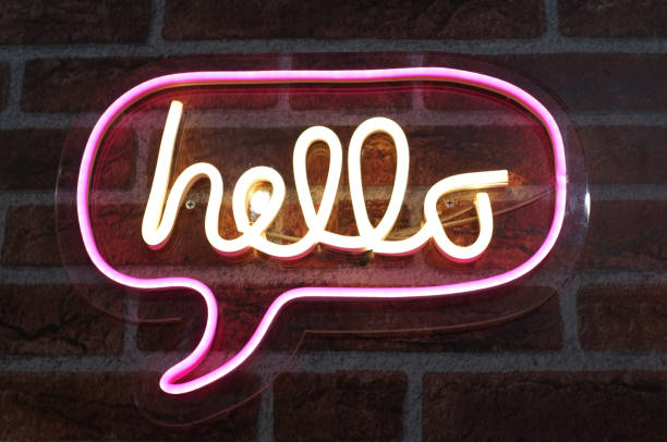 Neon sign background saying " HELLO " Sign hanging on a wall and lit brightly. Neon sign background saying " HELLO " Sign hanging on a wall and lit brightly. number of people stock pictures, royalty-free photos & images