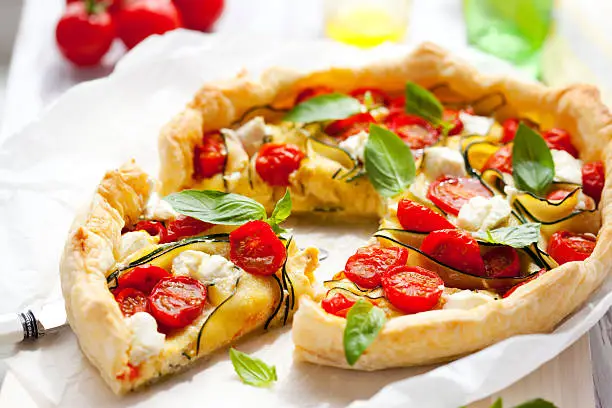 Quiche with tomato,zucchini, cheese and basil