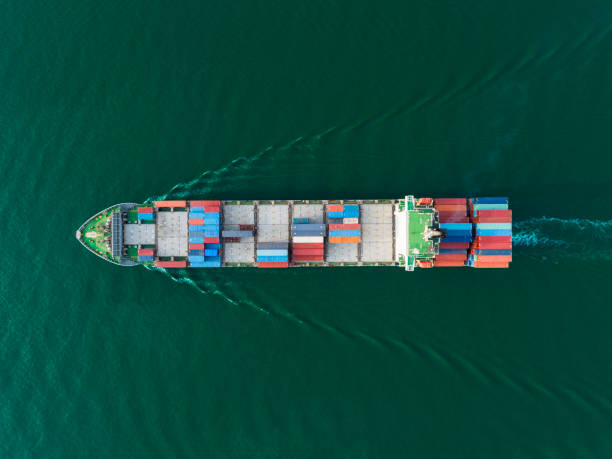 istock Aerial top view container ship on deep sea with beautiful wave pattern for logistics, import export, shipping or transportation to worldwide. 1150402101