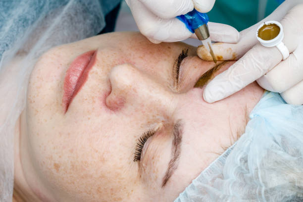 istock Permanent makeup, tattooing of eyebrows. Cosmetologist applying make up 1150402924