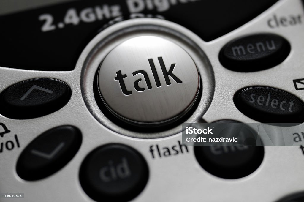 Cordless Telephone Talk Button Close-up Macro of a silver and black telephone with the word talk and other buttons.  Black Color Stock Photo
