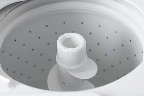 Inside of a Modern White Top Loader Washing Machine stock photo