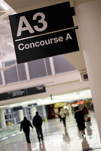 istock Airport Terminal Concourse and Gate Sign with People Walking 115040594