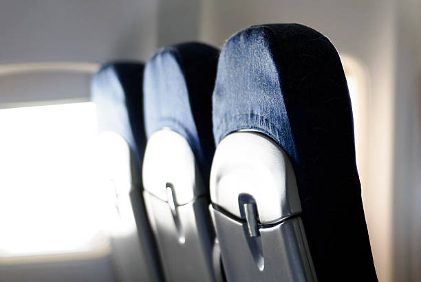 istock Three Airplane Seat Backs on a Commercial Passenger Jet 115040604