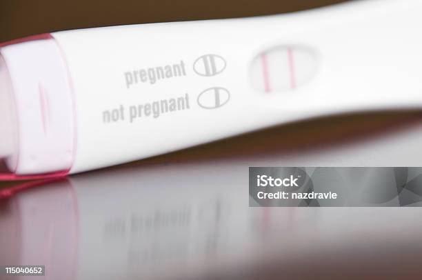 Positive Pregnancy Test Closeup On A Brown Wooden Table Stock Photo - Download Image Now