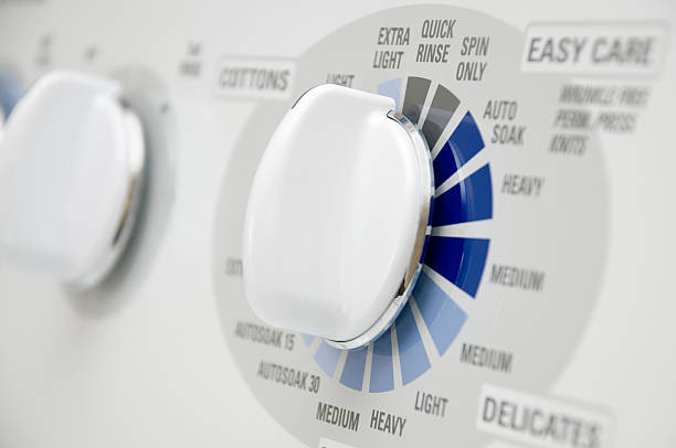 istock Modern White Washing Machine Appliance Dials Close-Up 115040663