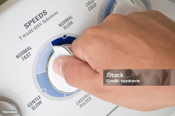 Male Hand Turning Modern Washing Machine Appliance Dial Stock Photo - Download Image Now