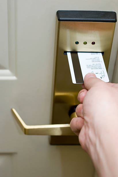 istock Male Hand Inserting Card Key into Electronic Hotel Door Lock 115040767