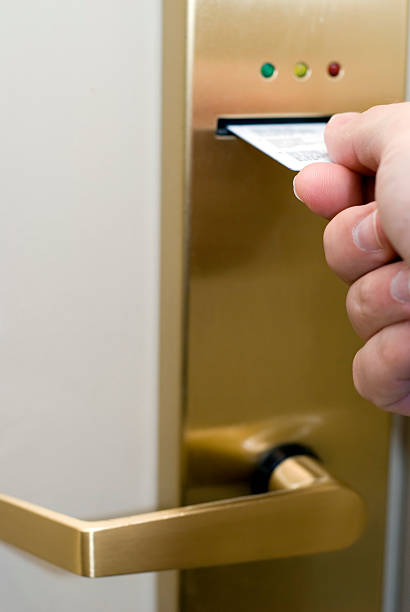istock Hand Inserting Hotel Room Electronic Door Lock Keycard 115040783