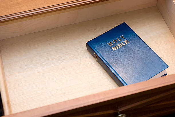 Blue Holy Bible in a Hotel Nightstand Drawer stock photo