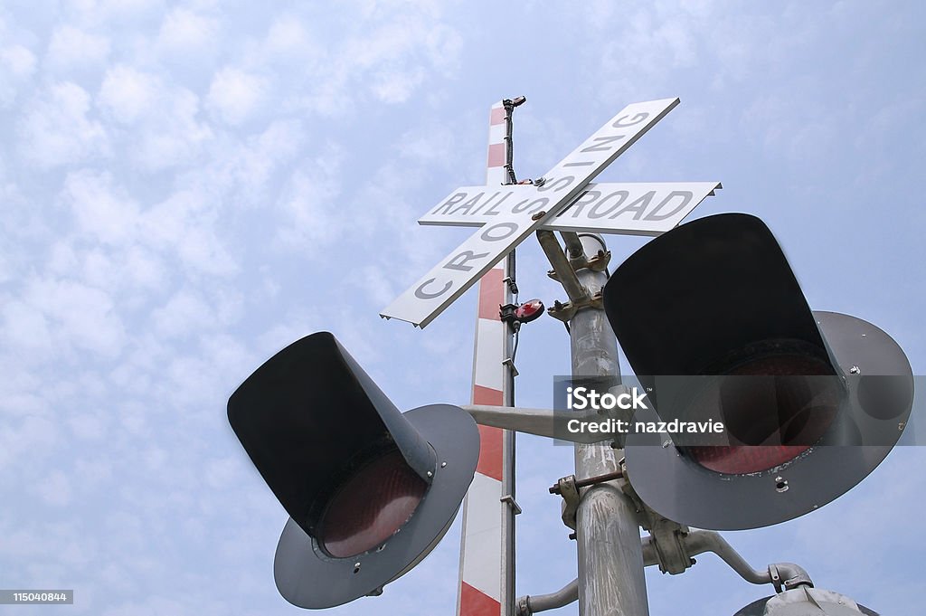 Railroad Crossing Signal Gate Lights with a Blue Sky Railroad crossing signal gate lights with a blue sky and clouds.  Blue Stock Photo
