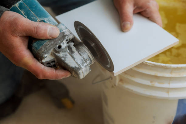 istock Worker cutting tile using grinder cut into layers of ceramic floor tiles 1150408609