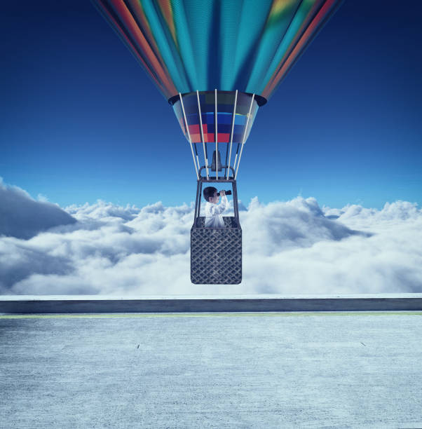 istock Young man flying with hot air balloon and looking through binoculars above clouds. 1150409272