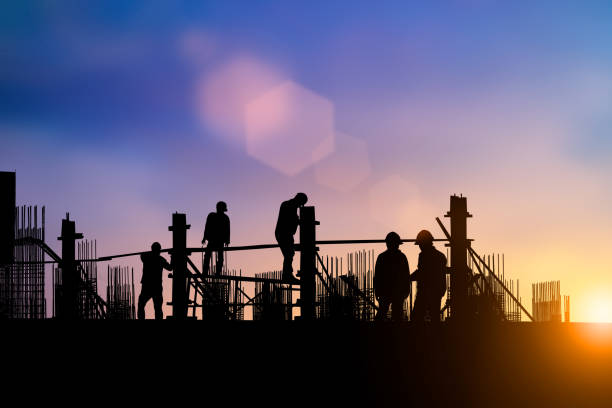 istock Silhouette of engineer and construction team working at site over blurred background for industry background with Light fair.Create from multiple reference images together 1150409555