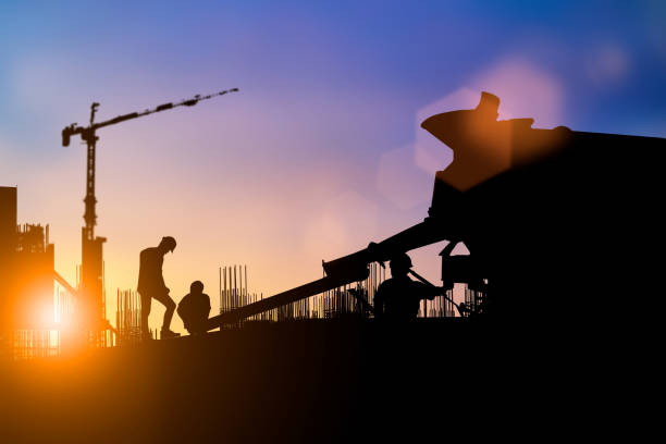 istock Silhouette of engineer and construction team working at site over blurred background for industry background with Light fair.Create from multiple reference images together 1150409556